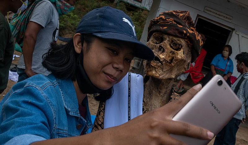 Indonesia Toraja Death Ritual where families dig dead relatives every year in august kph