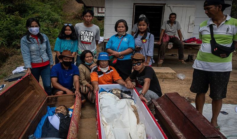 Indonesia Toraja Death Ritual where families dig dead relatives every year in august kph