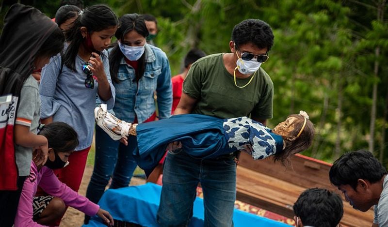 Indonesia Toraja Death Ritual where families dig dead relatives every year in august kph