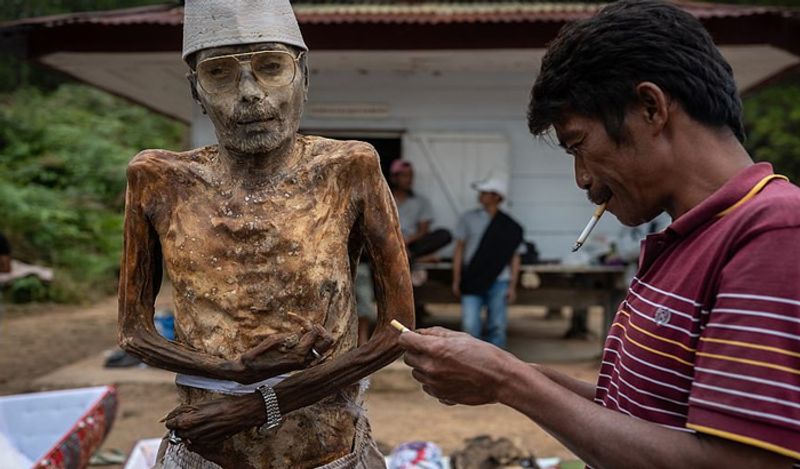 Indonesia Toraja Death Ritual where families dig dead relatives every year in august kph