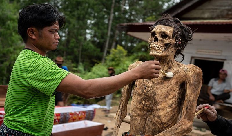 Indonesia Toraja Death Ritual where families dig dead relatives every year in august kph