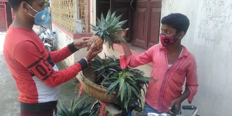 A school student sells pineapple to earn money during lockdown in Malda BTG