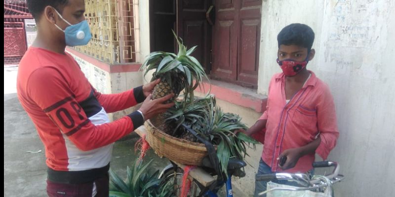 A school student sells pineapple to earn money during lockdown in Malda BTG