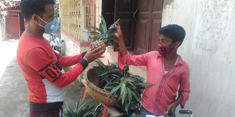 A school student sells pineapple to earn money during lockdown in Malda BTG