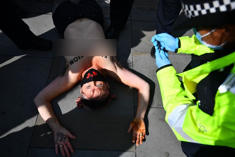 bare chest protest in front of british parliament protest