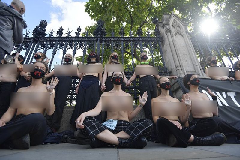 bare chest protest in front of british parliament protest