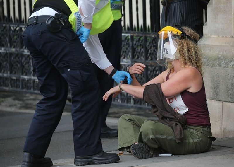 bare chest protest in front of british parliament protest