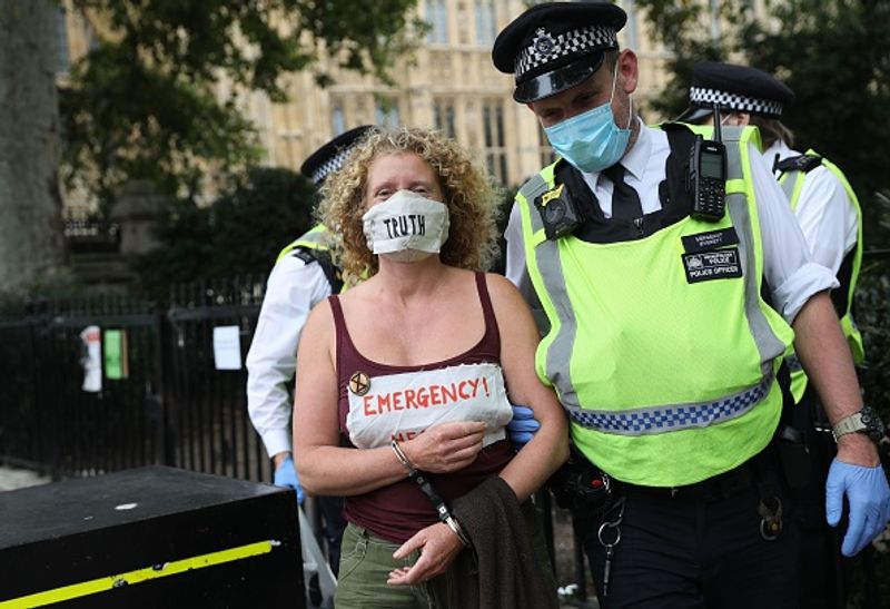 bare chest protest in front of british parliament protest