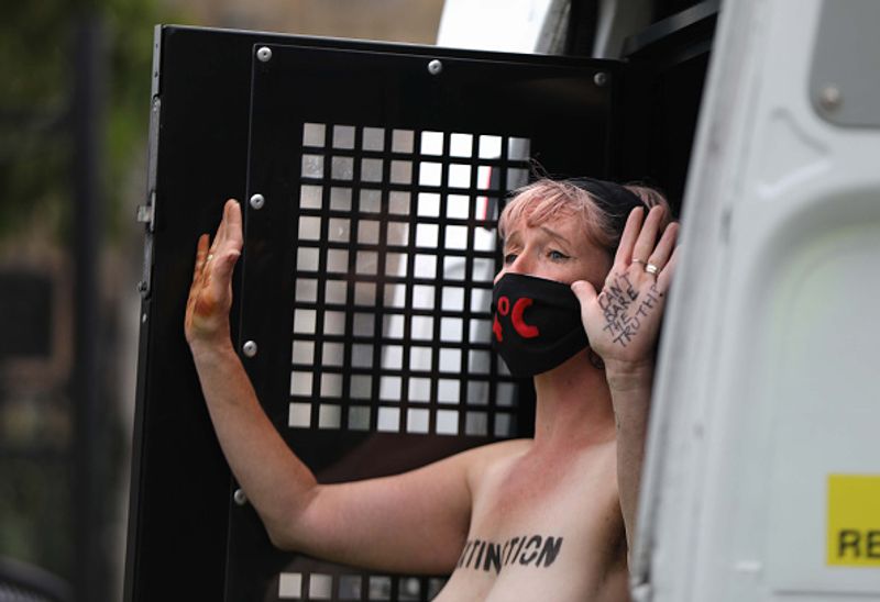 bare chest protest in front of british parliament protest