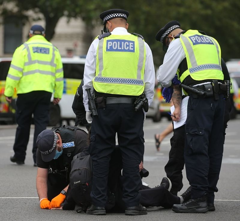 bare chest protest in front of british parliament protest