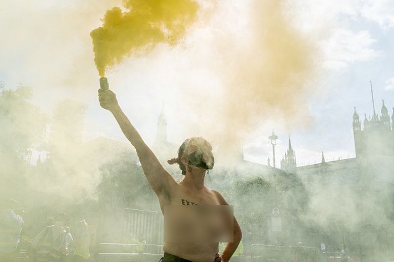 bare chest protest in front of british parliament protest