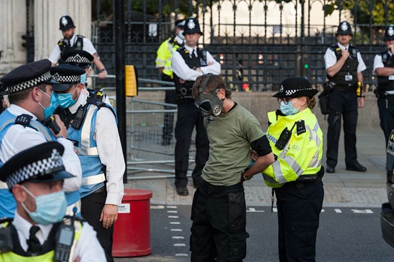 bare chest protest in front of british parliament protest