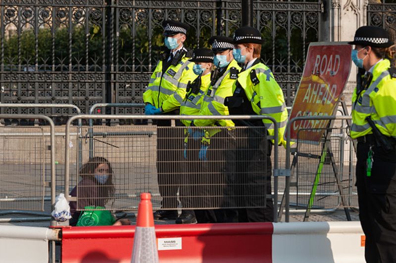 bare chest protest in front of british parliament protest
