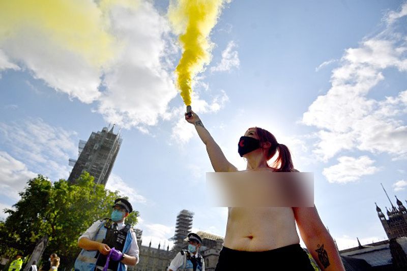 bare chest protest in front of british parliament protest