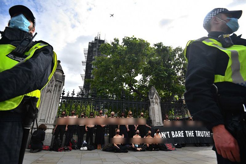 bare chest protest in front of british parliament protest