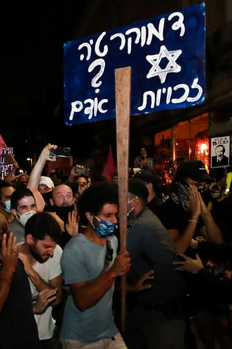 New law to curb anti-government protesters Israelis shouting slogans