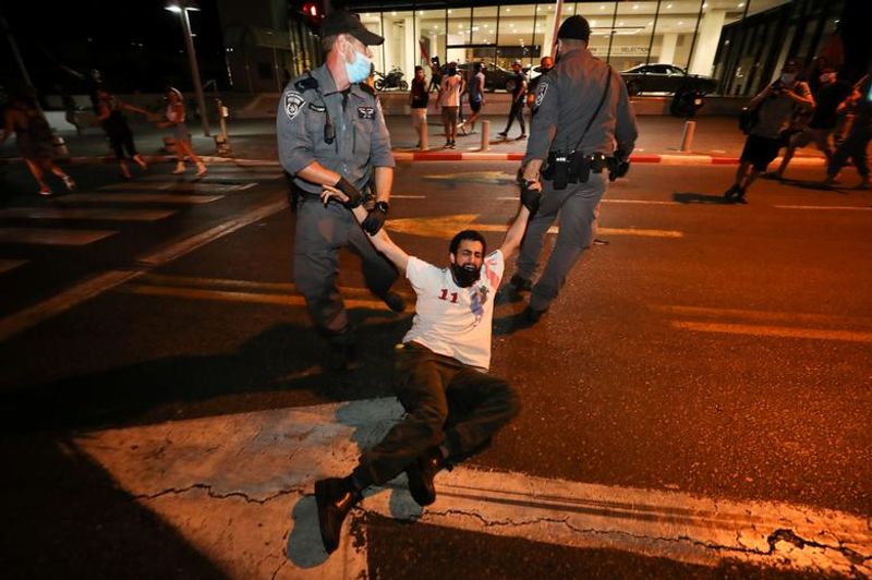 New law to curb anti-government protesters Israelis shouting slogans