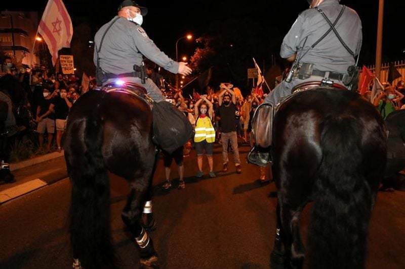 New law to curb anti-government protesters Israelis shouting slogans