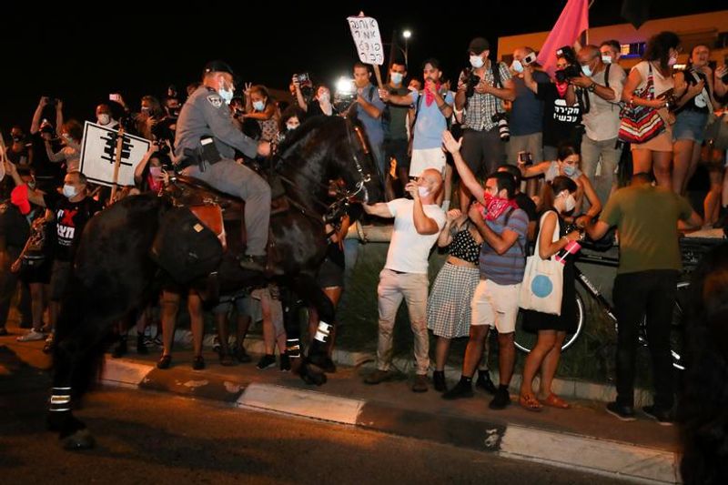 New law to curb anti-government protesters Israelis shouting slogans