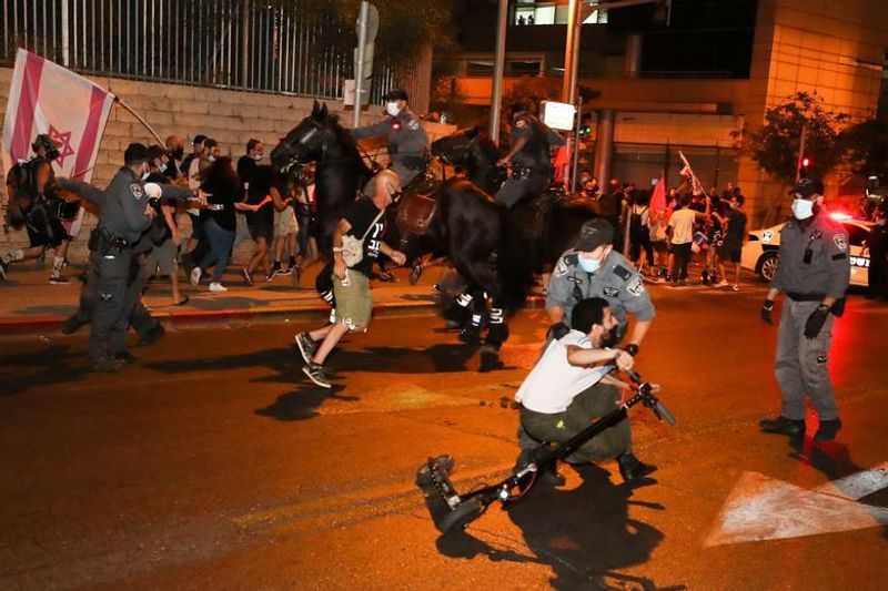 New law to curb anti-government protesters Israelis shouting slogans