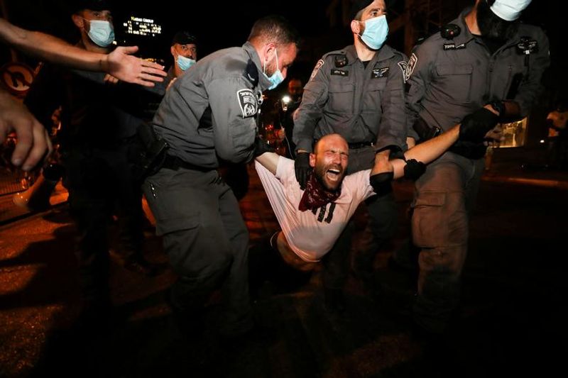 New law to curb anti-government protesters Israelis shouting slogans