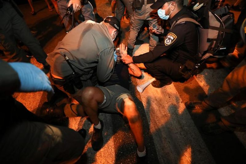 New law to curb anti-government protesters Israelis shouting slogans