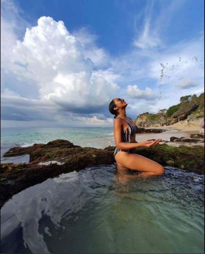 Bikini girl Tejaswi Madivada walking on the shores of ocean