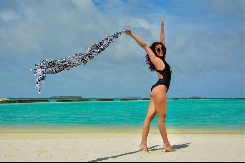 Bikini girl Tejaswi Madivada walking on the shores of ocean