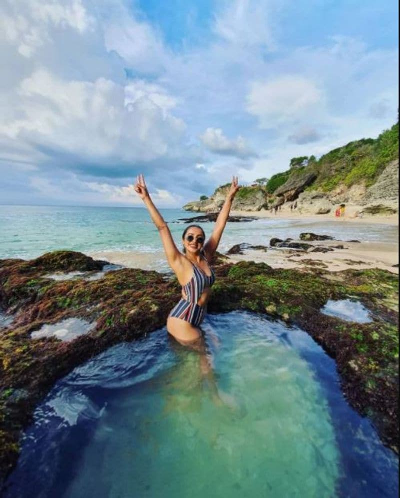 Bikini girl Tejaswi Madivada walking on the shores of ocean
