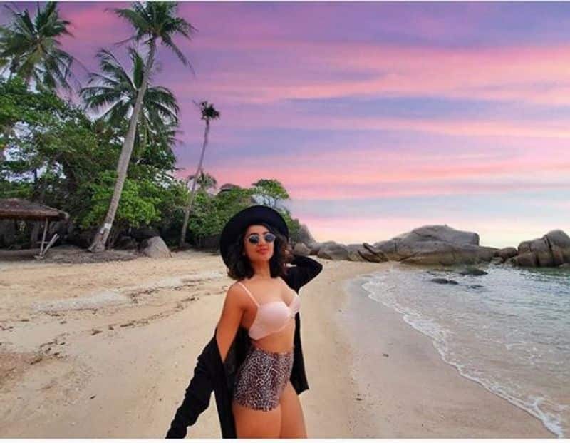 Bikini girl Tejaswi Madivada walking on the shores of ocean