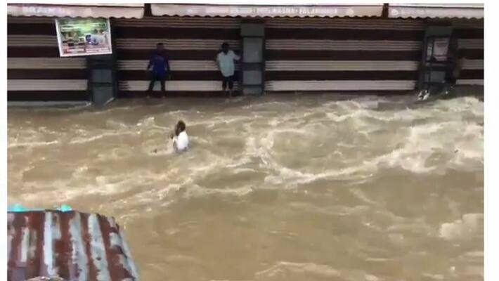 Man washed awamy in flood water in Hyderabad lns Man washed awamy in flood water in Hyderabad lns