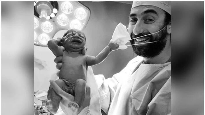 newborn baby trying to remove her doctors surgical mask has become a viral newborn baby trying to remove her doctors surgical mask has become a viral