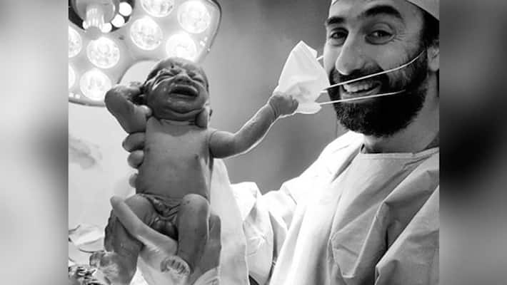 Newborn Baby Try To Remove Doctors Surgical Mask in uae ksp Newborn Baby Try To Remove Doctors Surgical Mask in uae ksp