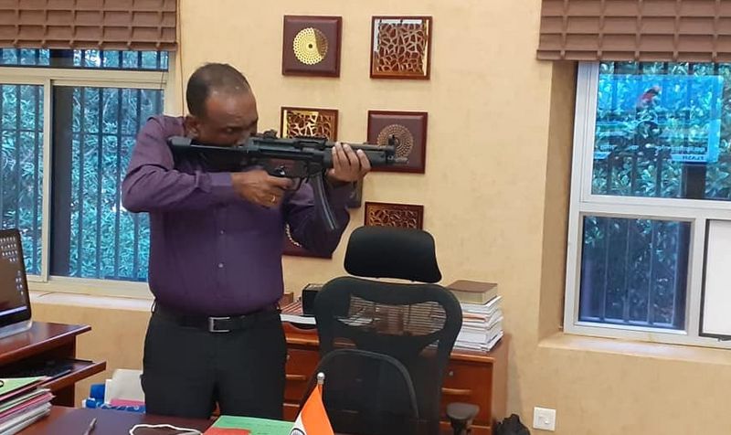 Manoj Abraham ips checking new MP5 rifle bought for the Kerala Police