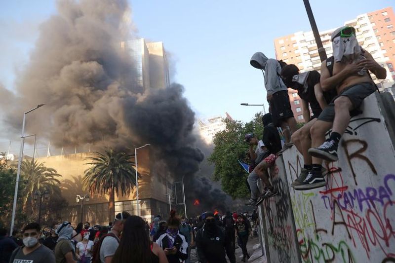 chilean protesters burn two churches photo story