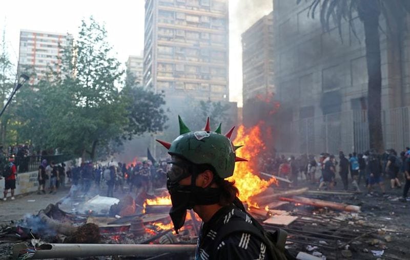 chilean protesters burn two churches photo story
