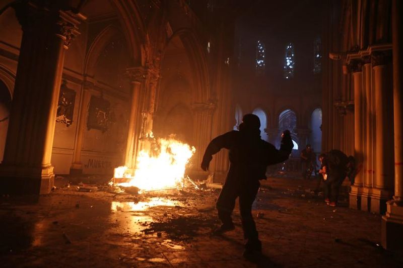 chilean protesters burn two churches photo story