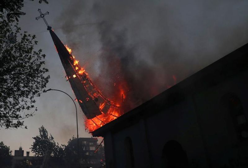 chilean protesters burn two churches photo story