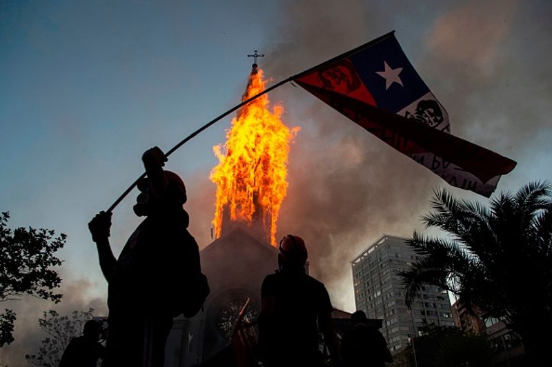 chilean protesters burn two churches photo story