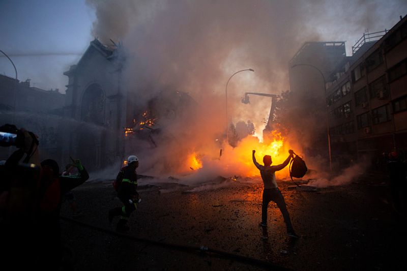 chilean protesters burn two churches photo story