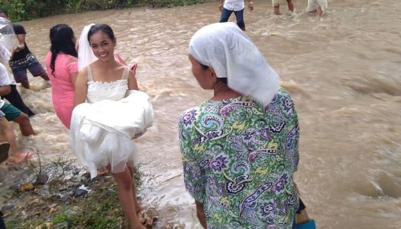 couple wades through floodwater to get married