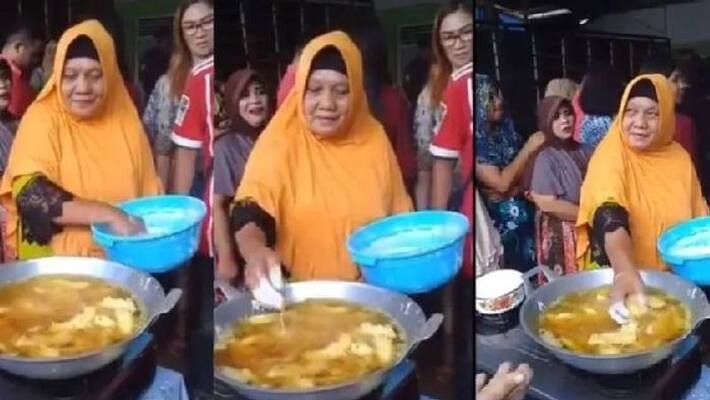 Woman Puts Her Bare Hand in Boiling Oil to Fry Food Woman Puts Her Bare Hand in Boiling Oil to Fry Food