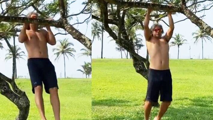 Milind Soman exercises by hanging from a tree branch KPG Milind Soman exercises by hanging from a tree branch KPG