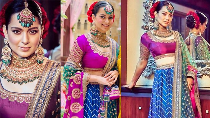 कंगना ने बैंगनी और गोल्डन रंग का लहंगा पहना। इसके साथ ही उन्होंने बड़ा-सा मांग टीका, हैवी नेकलेस और बड़े-बड़े झुमके से अपने लुक को कम्प्लीट किया। ओवरऑल कंगना का लुक एकदम रॉयल लग रहा था। 