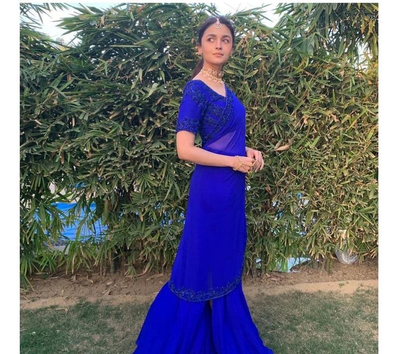 <p style="text-align: justify;"><strong>A solid colour breezy saree</strong></p>
<p style="text-align: justify;">Alia Bhatt wore a classic Manish Malhotra's sheer Royal blue coloured saree at her bestie's wedding shenanigans. The actress completed her look with a contrasting pink-stone choker, mang tika, and nude makeup. Looking very Indian and chic.</p>
<p style="text-align: justify;"> </p>
