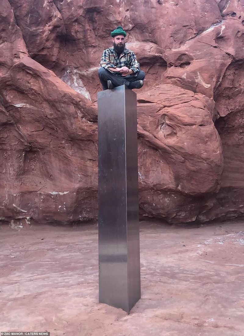 12 foot tall metal structure between the red rock mountain in Utah Desert photostory