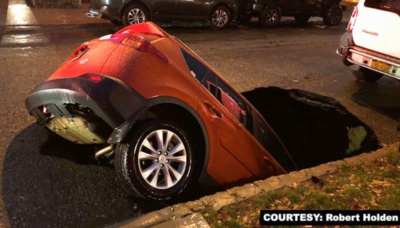 PHOTOS Waking up to see an SUV in a sinkhole-tgy