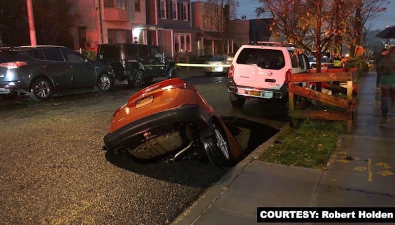 PHOTOS Waking up to see an SUV in a sinkhole-tgy