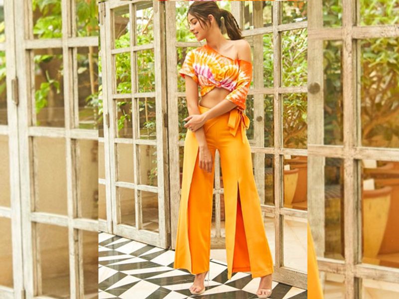 Ananya Panday
Ananya Panday looked radiantly beautiful in a yellowish-orange co-ord pant set with a tie-dye one-shoulder top. She kept her makeup minimal and tied her hair in a pony.
