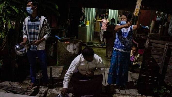 People in Myanmar protest by clinging pots and honking horns People in Myanmar protest by clinging pots and honking horns